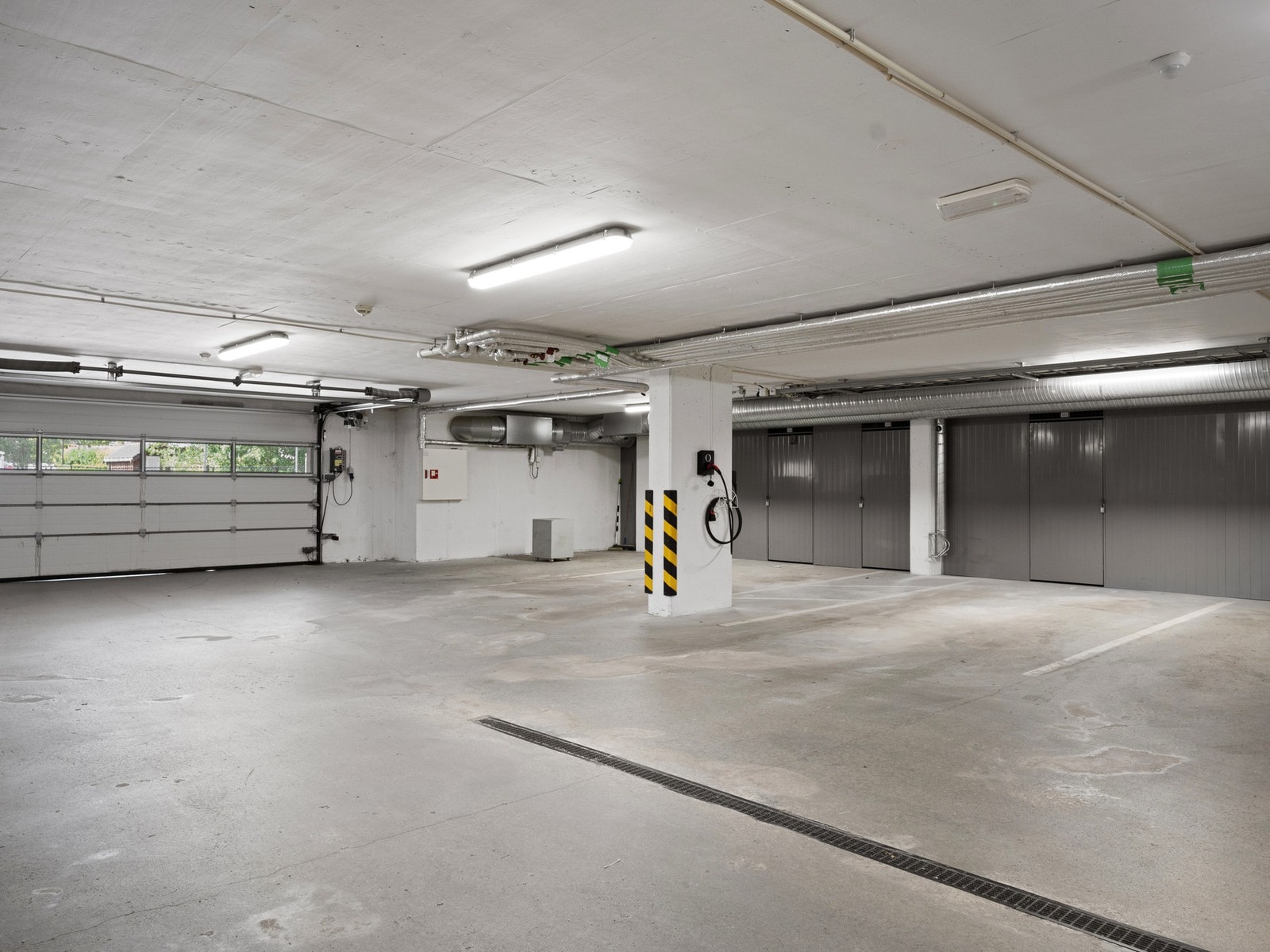 Parkering i lukket anlegg med el-bil lader, samt sportsbod. Galleribilde