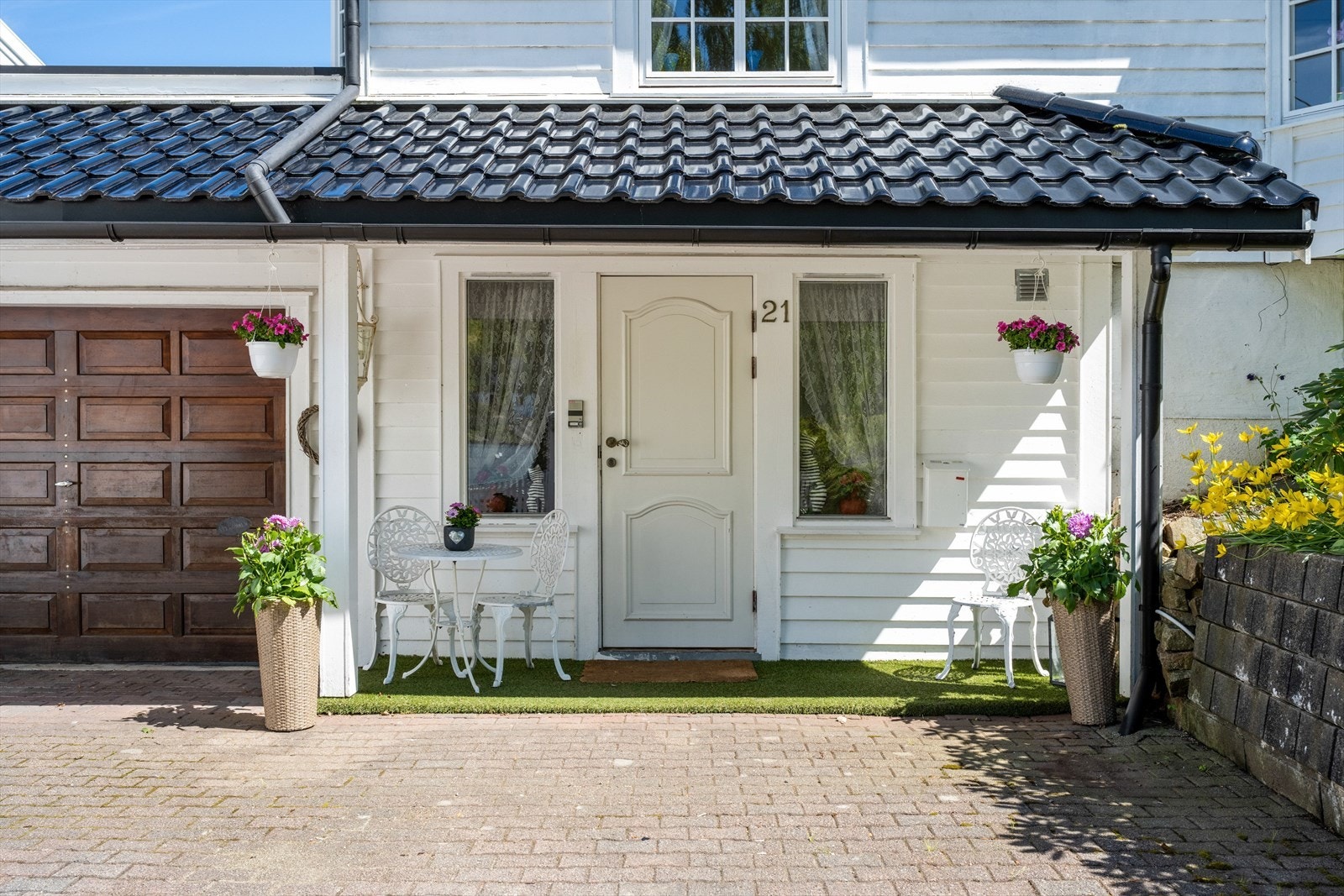 Overbygget inngangsparti som leder inn til en romslig entré i første etasje. Galleribilde
