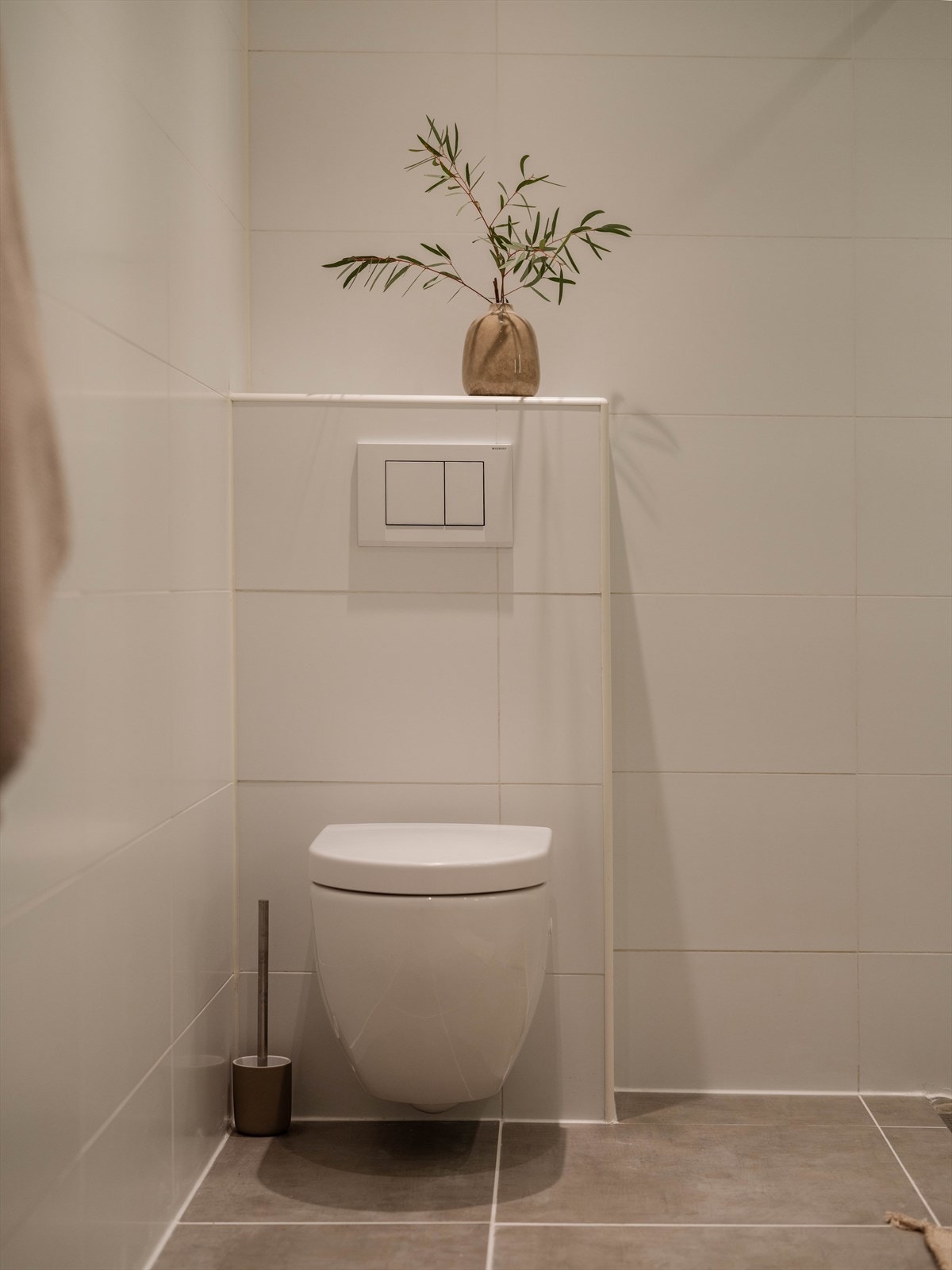 Badet har vegghengt toalett og opplegg for vaskemaskin og tørketrommel. Galleribilde