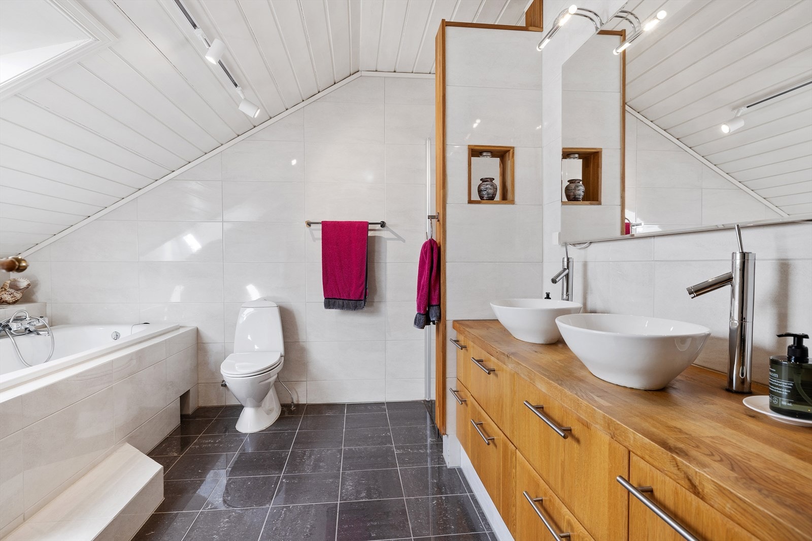 Badet på loftet, oppgradert ca. 2009/2010, har en stor servantinnredning med benkeplate i eik og to toppmonterte servanter. Galleribilde