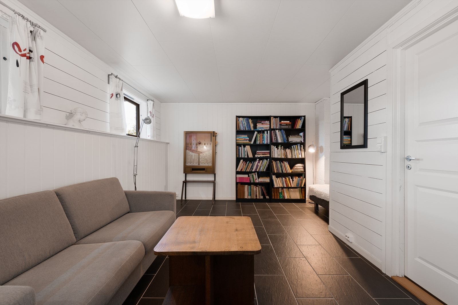 Kjellerstuen er et allsidig rom. På opprinnelige byggetegninger var rommet inndelt i to soverom. Galleribilde