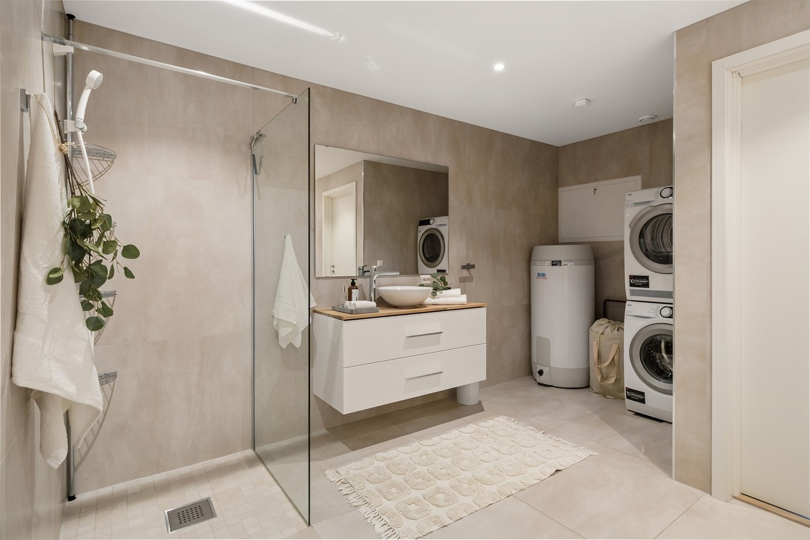 Badet er utstyrt med bl.a. innredning med bollevask, vegghengt toalett, badekar, et separat dusjhjørne og opplegg for vaskemaskin. Galleribilde