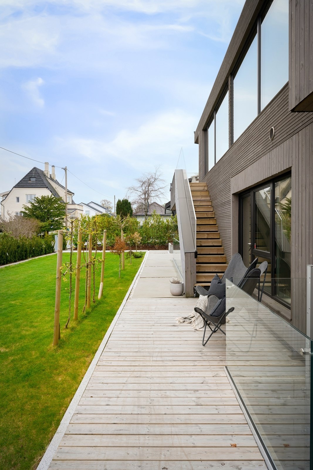 Fra første etasje er det utgang til en stor treterrasse som strekker seg langs deler av huset. Galleribilde