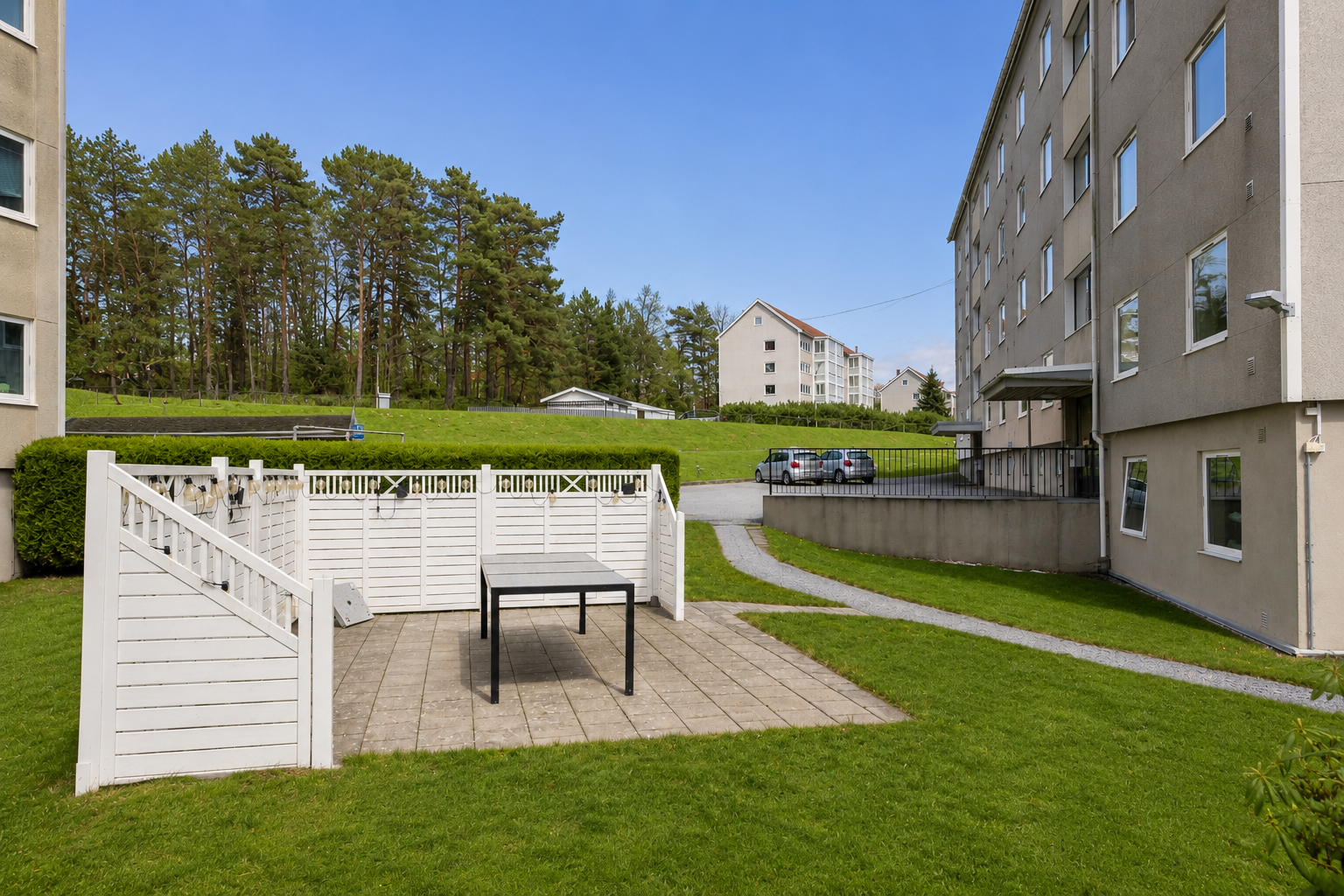 Opparbeidet fellesareale med parkering, plen, gangstier og uteplasser. Sesongendret med AI. Galleribilde