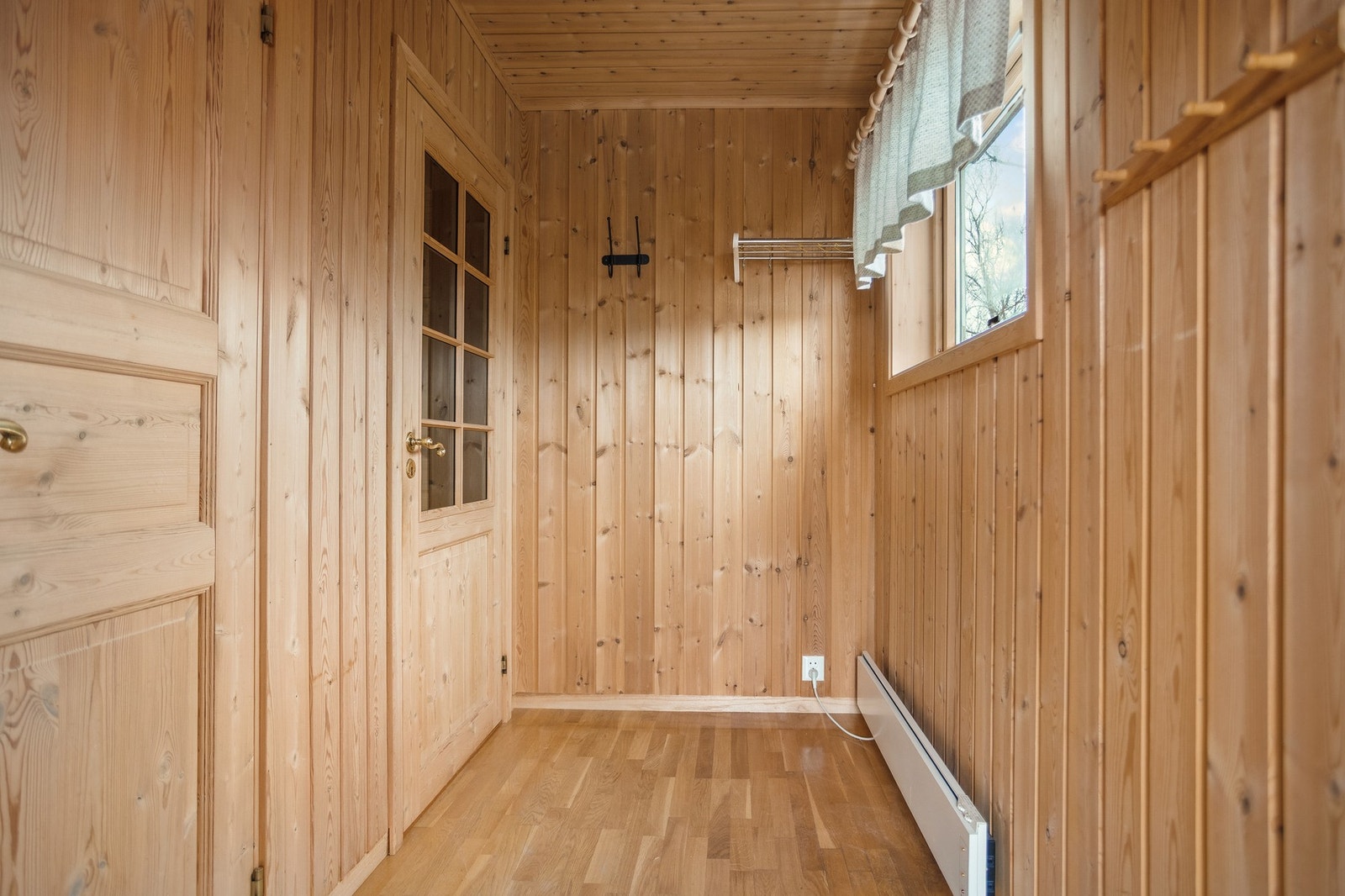 Entré med trepanel og knagger til yttertøy. Galleribilde