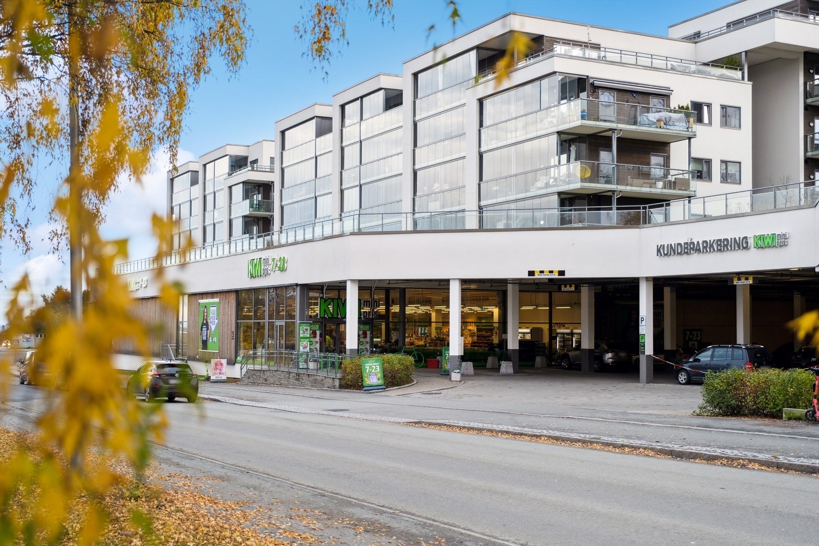 På bakkeplan like ved hovedveien ligger en lys og trivelig Kiwi-butikk, og like bortenfor en søndagsåpen Bunnpris. Galleribilde