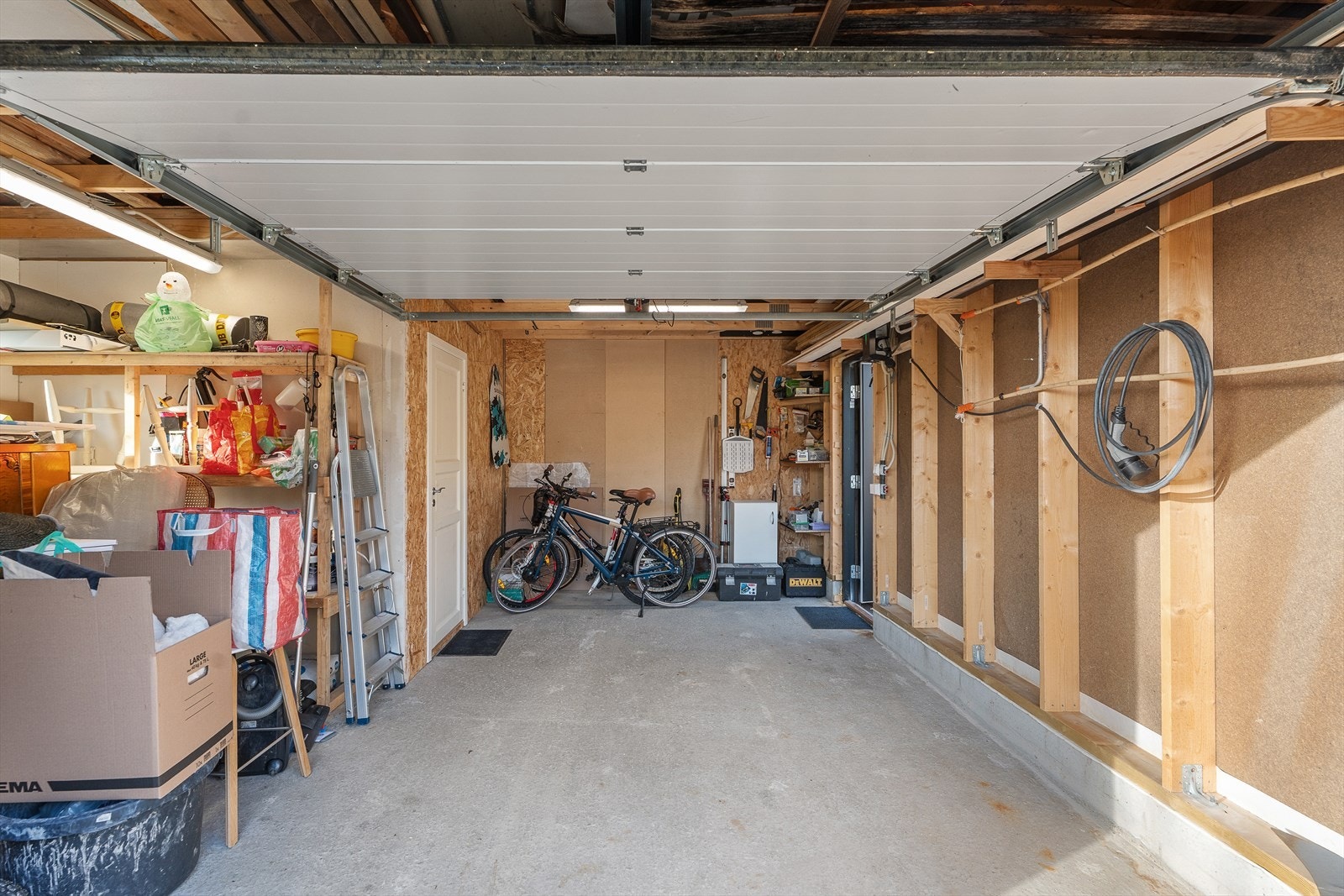 Garasje på ca. 21m² med el-bil lader, garasjeport og gode oppbevaringsmuligheter. Galleribilde