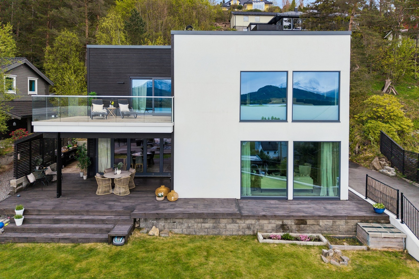 - som har en pent opparbeidet tomt med hage, terrasser, pergola - Galleribilde