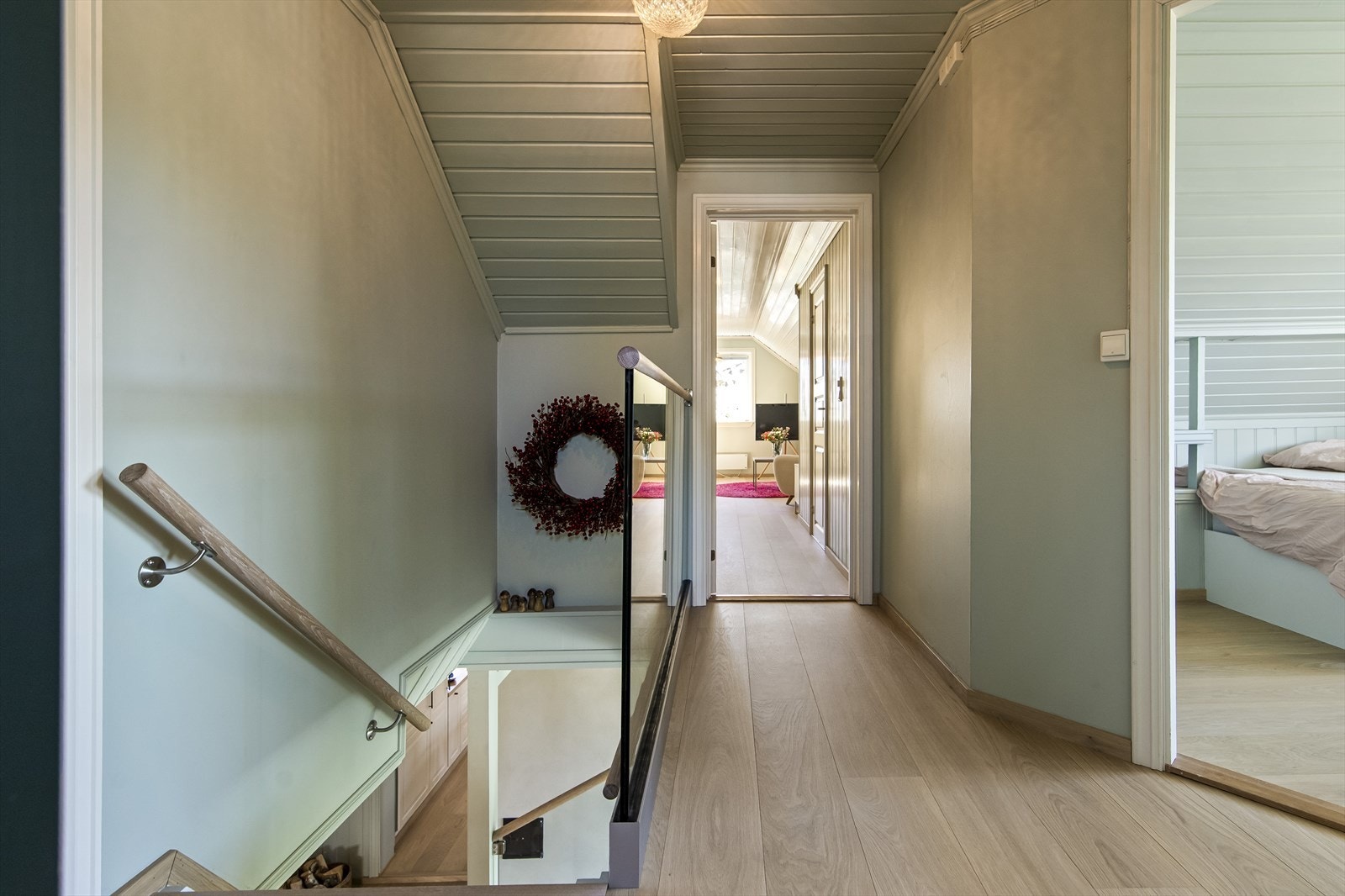 Trappen til 2. etasje har glassrekkverk øverst, og ender i en grønnmalt gang med tilliggende kontor. Galleribilde