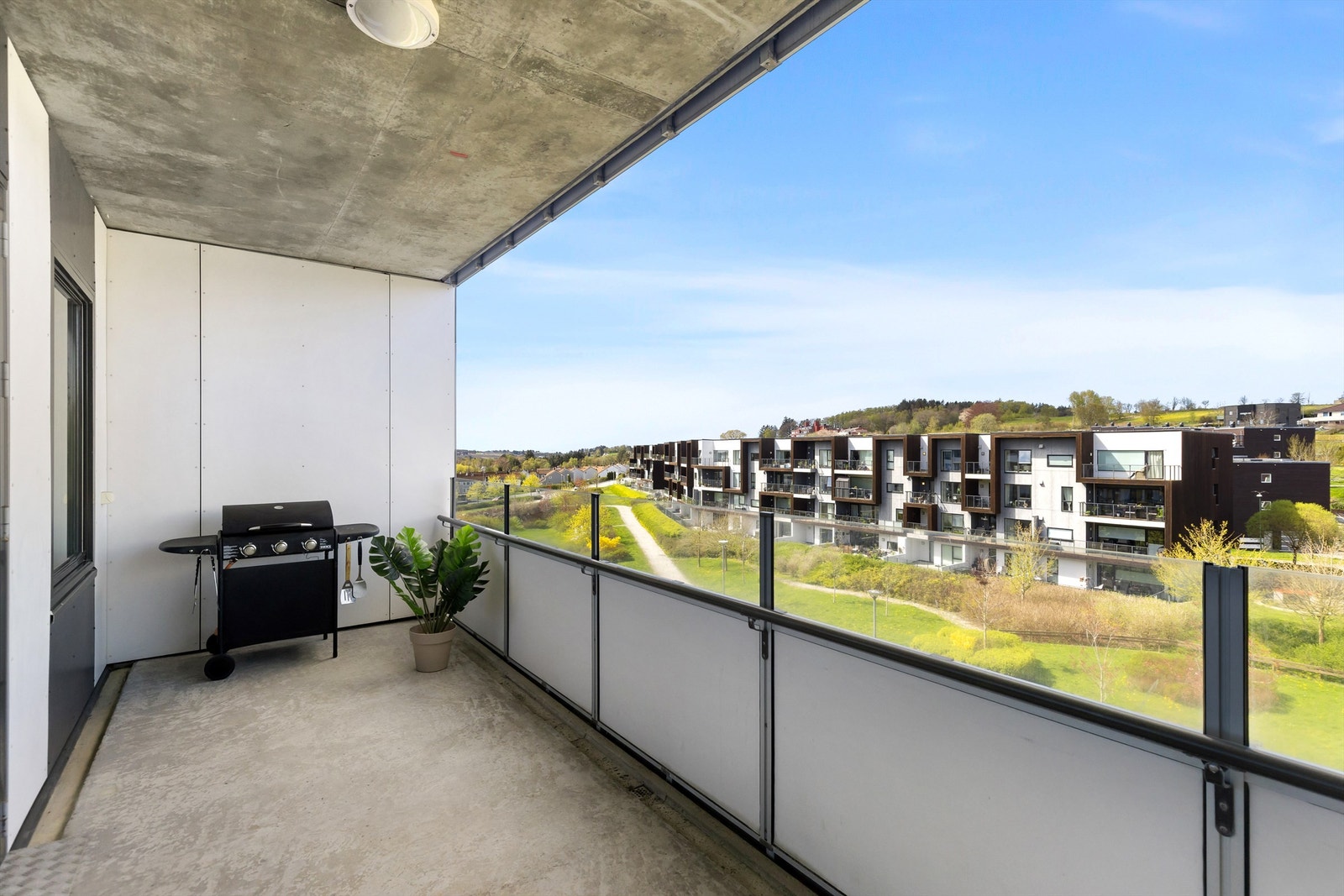 Den romslige balkongen på 13 m² gir rikelig med plass for en sittegruppe og har utsikt over grønne fellesområder. Galleribilde