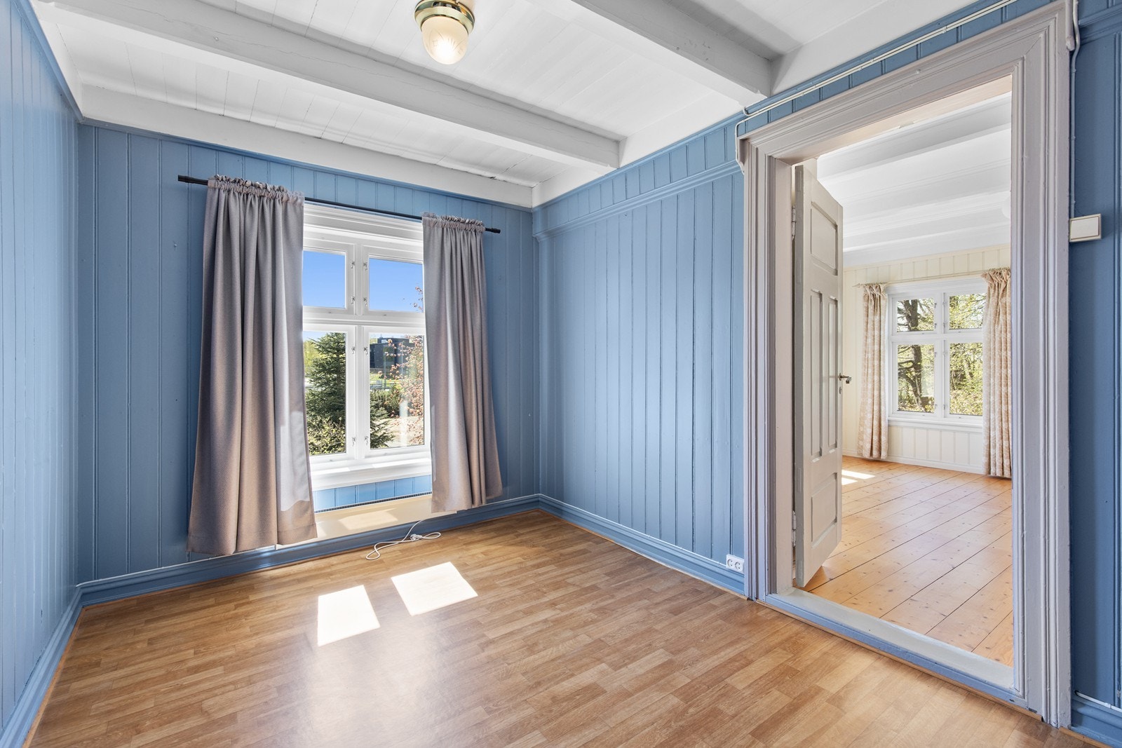 Soverom med malt panel og stort vindu. Galleribilde