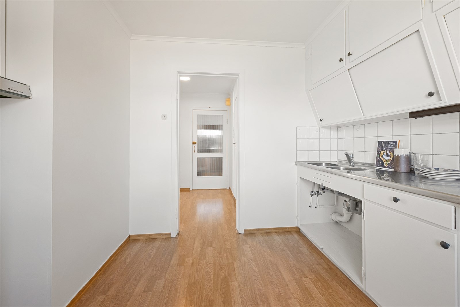 Kjøkkenet har en praktisk innredning med glatte fronter og ventilator med avtrekk ut. Galleribilde