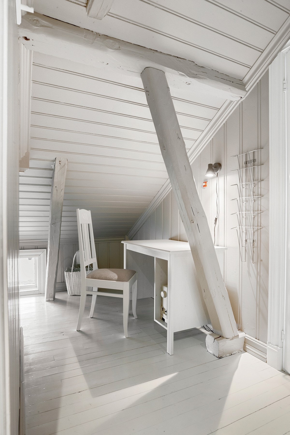 Kontor / arbeidsbord på loftstue med lagringsplass på siden Galleribilde