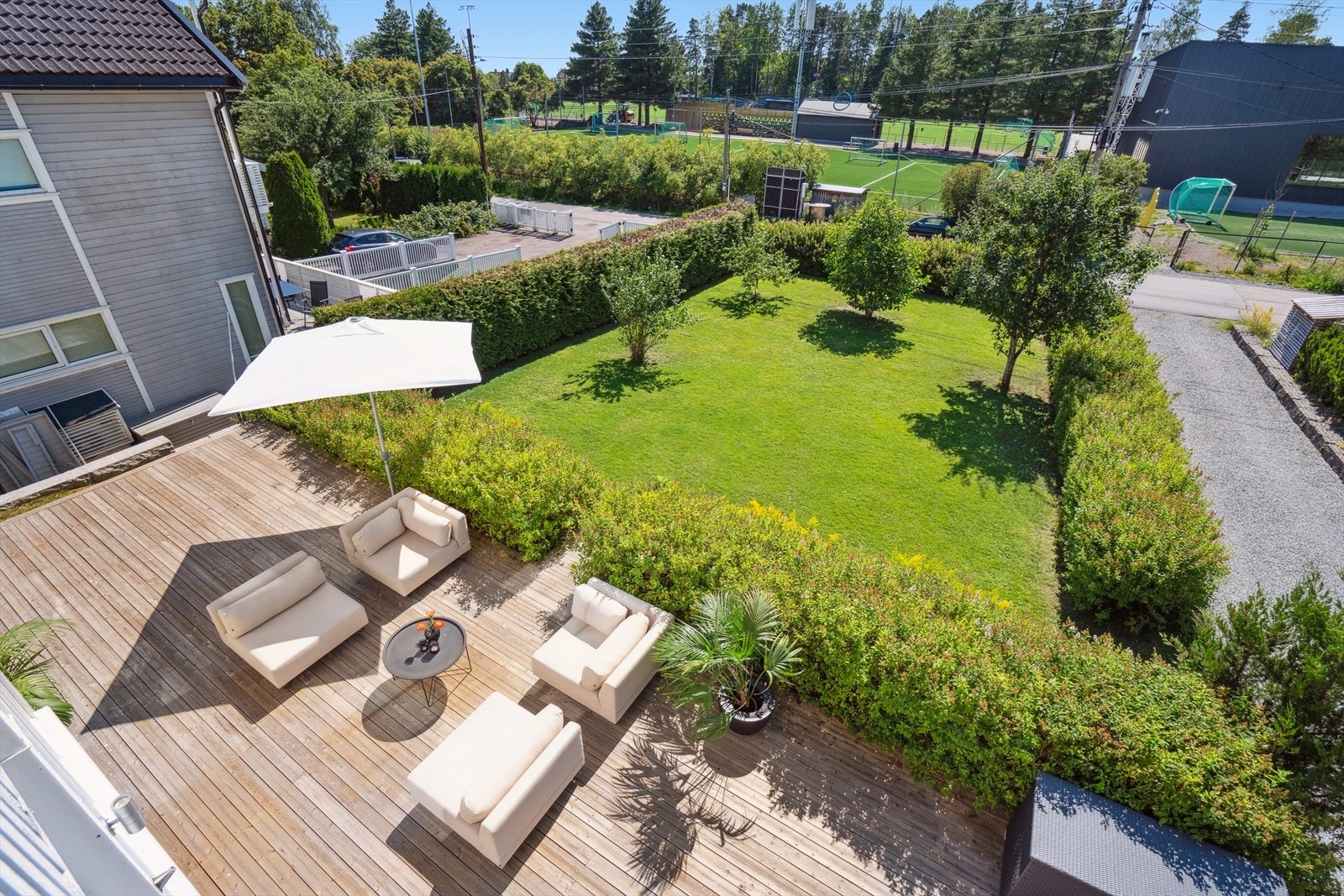 Stor, flat tomt som er pent opparbeidet med plen og beplantning. Galleribilde