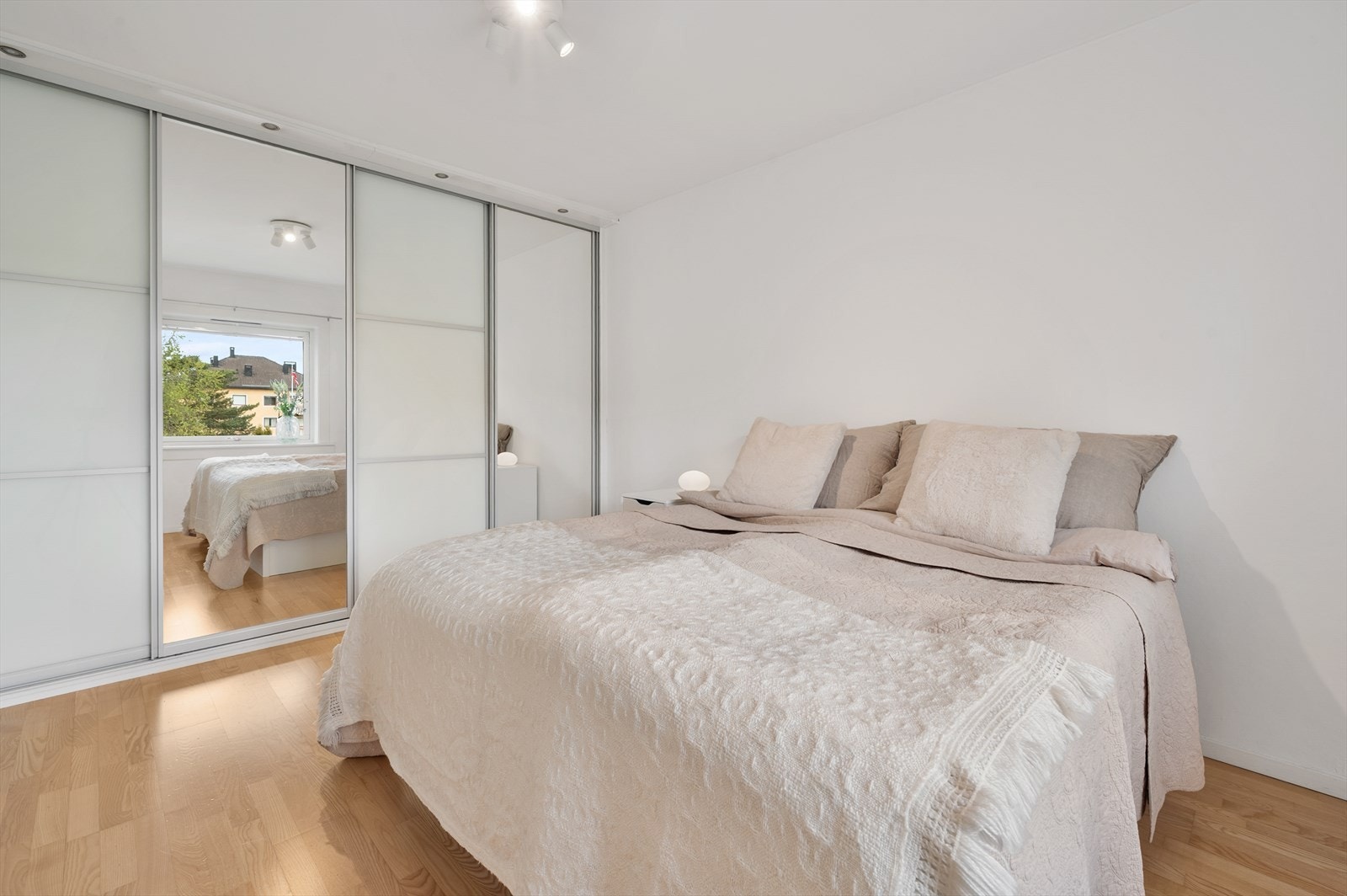 En stor skyvedørsgarderobe med speilfronter gir rikelig med oppbevaringsplass. Galleribilde