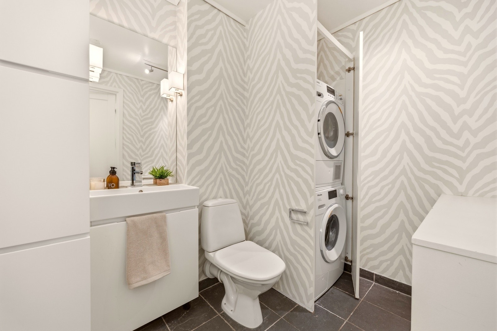 Praktisk vaskerom/wc med opplegg til vaskemaskin og tørketrommel. Rommet har også innebygd skittentøysjakt med nedkast fra hovedbadet i 2. etasje. Galleribilde
