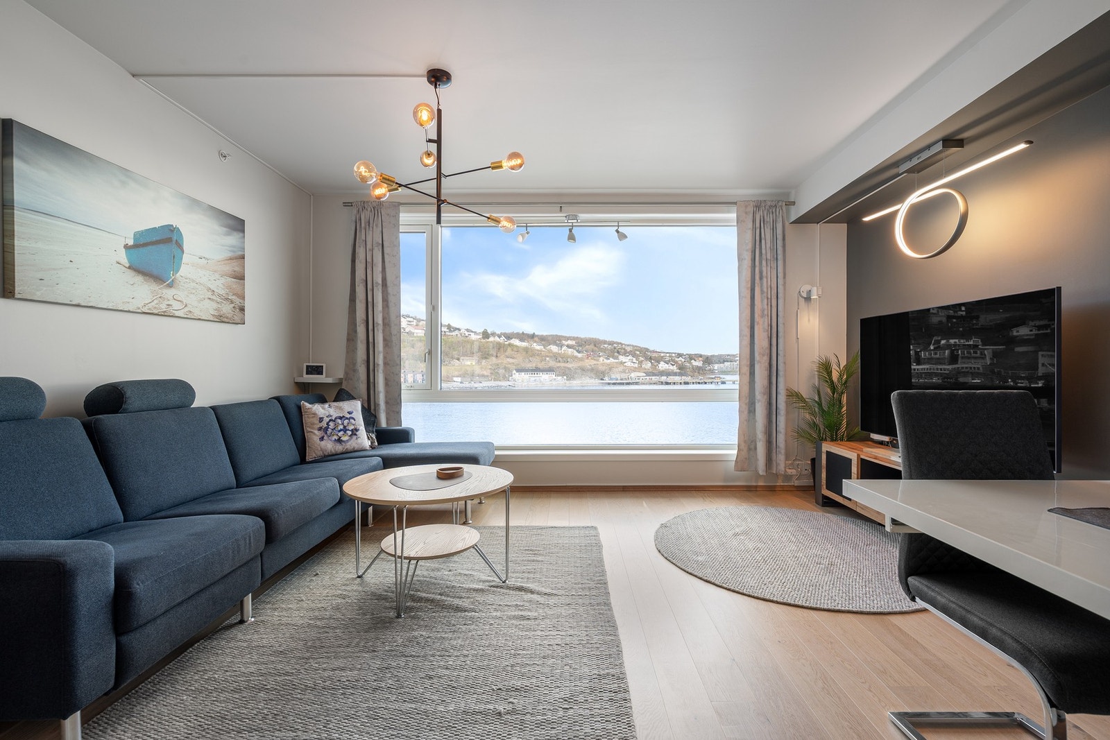 Leiligheten er vendt mot havet med stuevindu som dekker omtrent hele veggen og sørger for rikelig dagslys inn Galleribilde