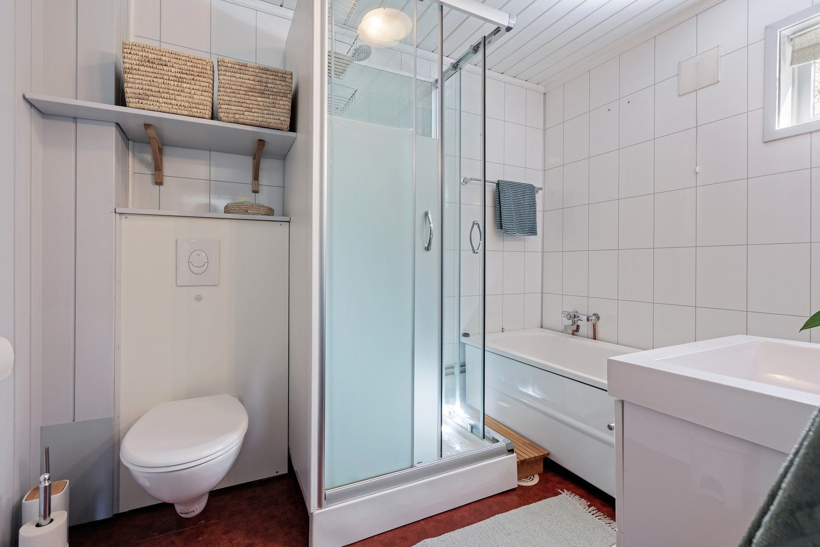 Pent bad med lyse overflater, dusjkabinett, badekar og moderne innredning. Galleribilde