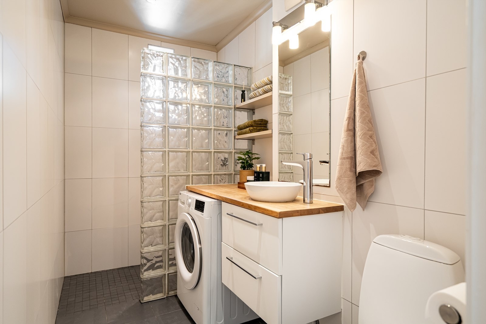 Badet er moderne utstyrt med benkeplate i heltre og ny servantskap fra 2024. Galleribilde