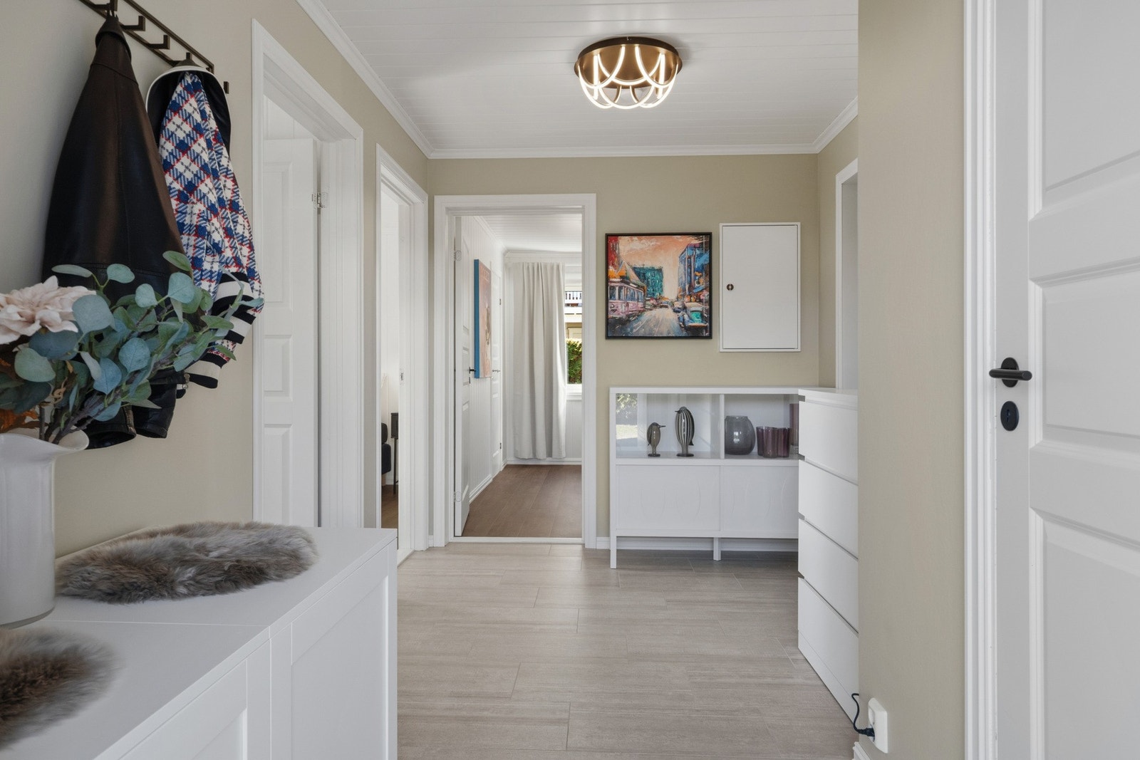 Entréen gir et lyst og innbydende førsteinntrykk med praktisk plass til oppbevaring av yttertøy og sko. Galleribilde