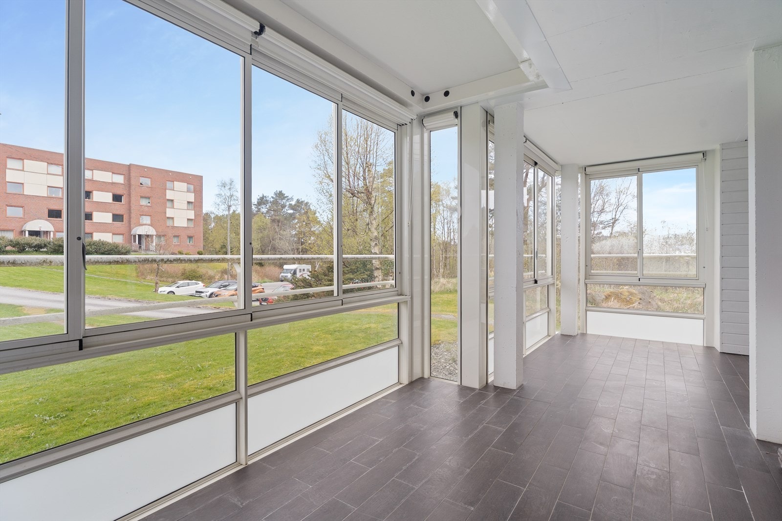 Leiligheten har en praktisk, gjennomgående planløsning i 1. etasje/byggets ende og kan skilte med stor, innglasset balkong. Galleribilde
