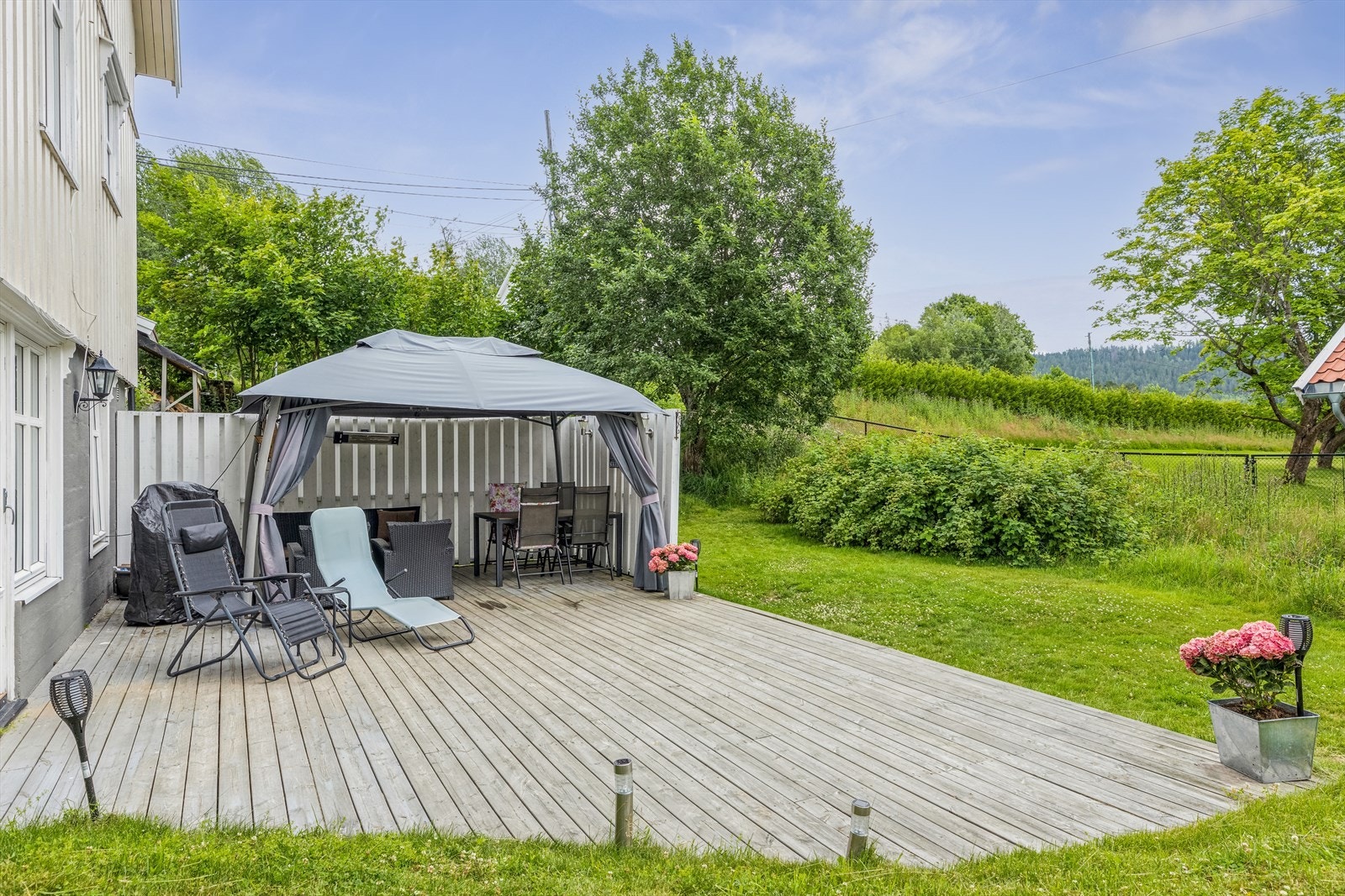 Solrik markterrasse utenfor stuen i utleiedelen. Galleribilde