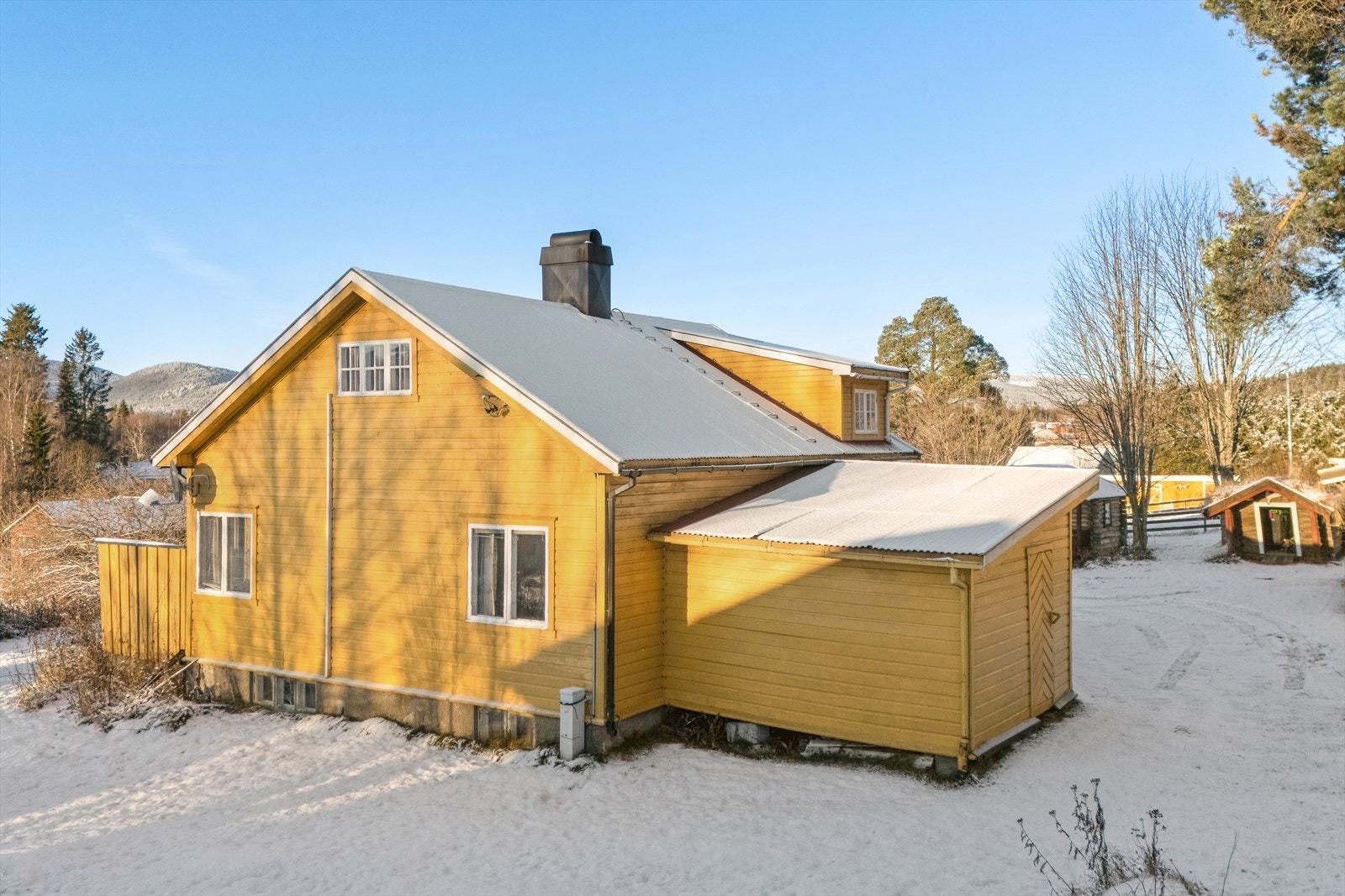 Boligen har utvendig liggende kledning og saltak tekket med metallplater. Galleribilde