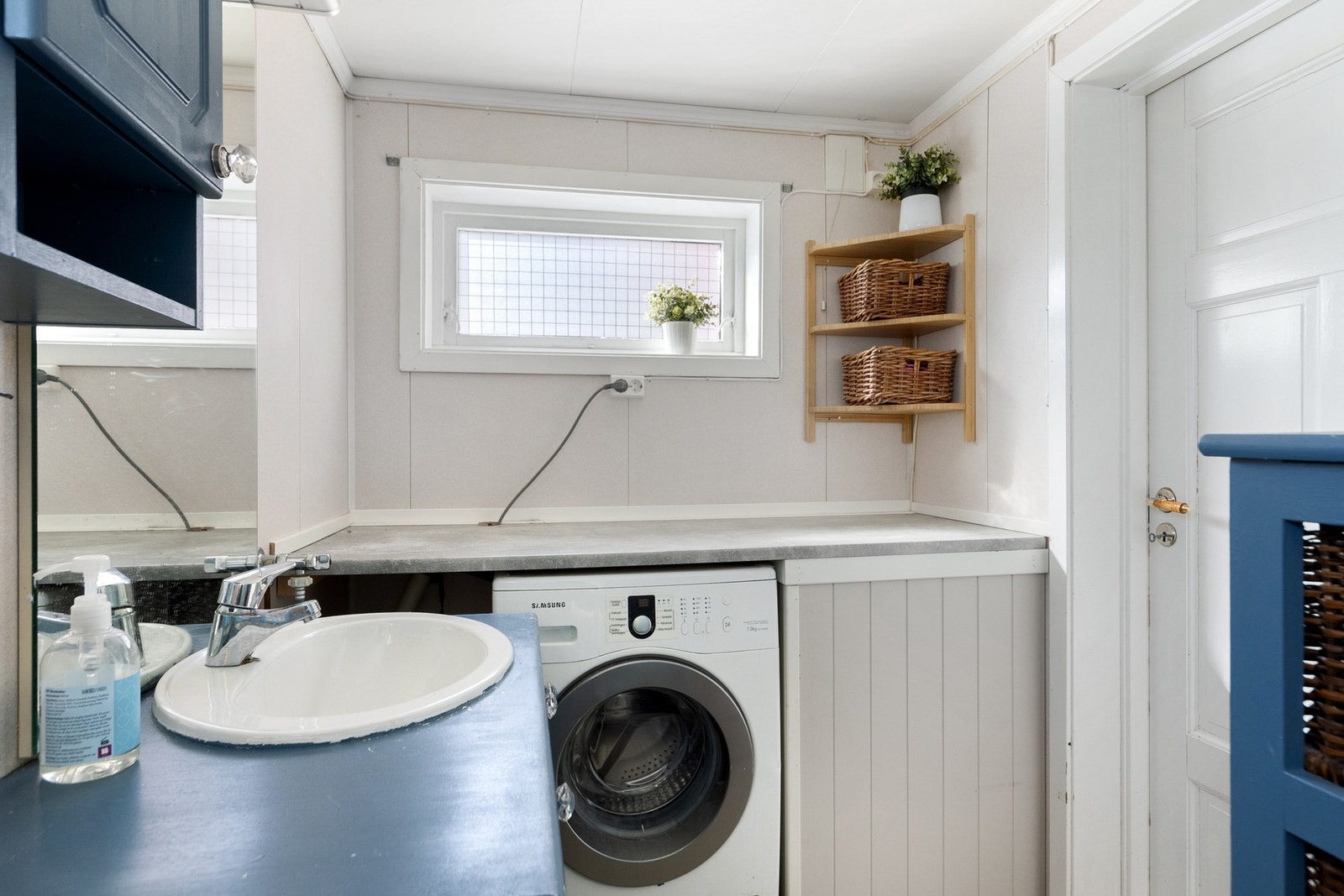 Badet er innredet med toalett, dusjkabinett, servantinnredning og opplegg for vaskemaskin. Galleribilde