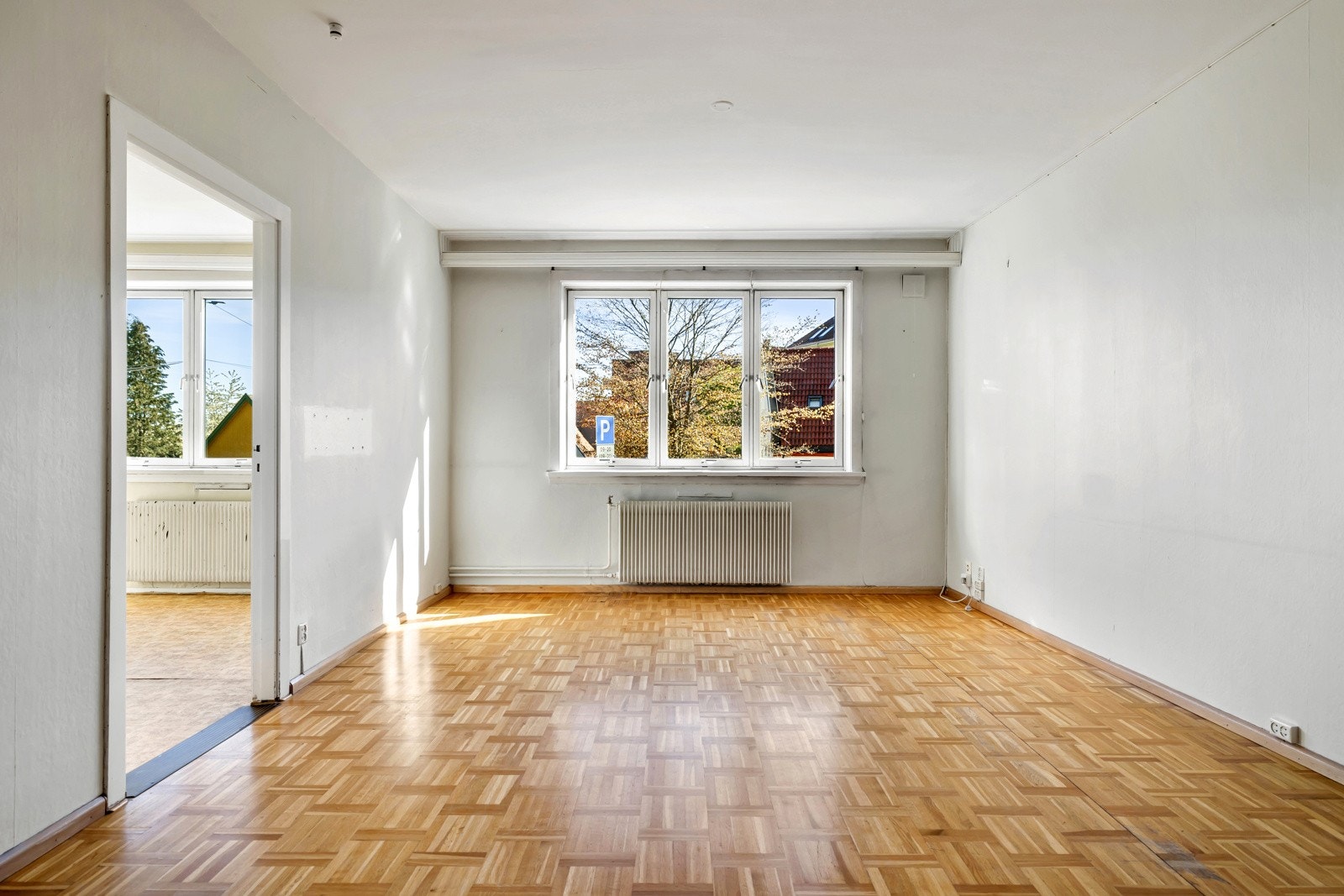 Leilighetens stue er romslig, her er det god plass til både sofa og spisebord Galleribilde