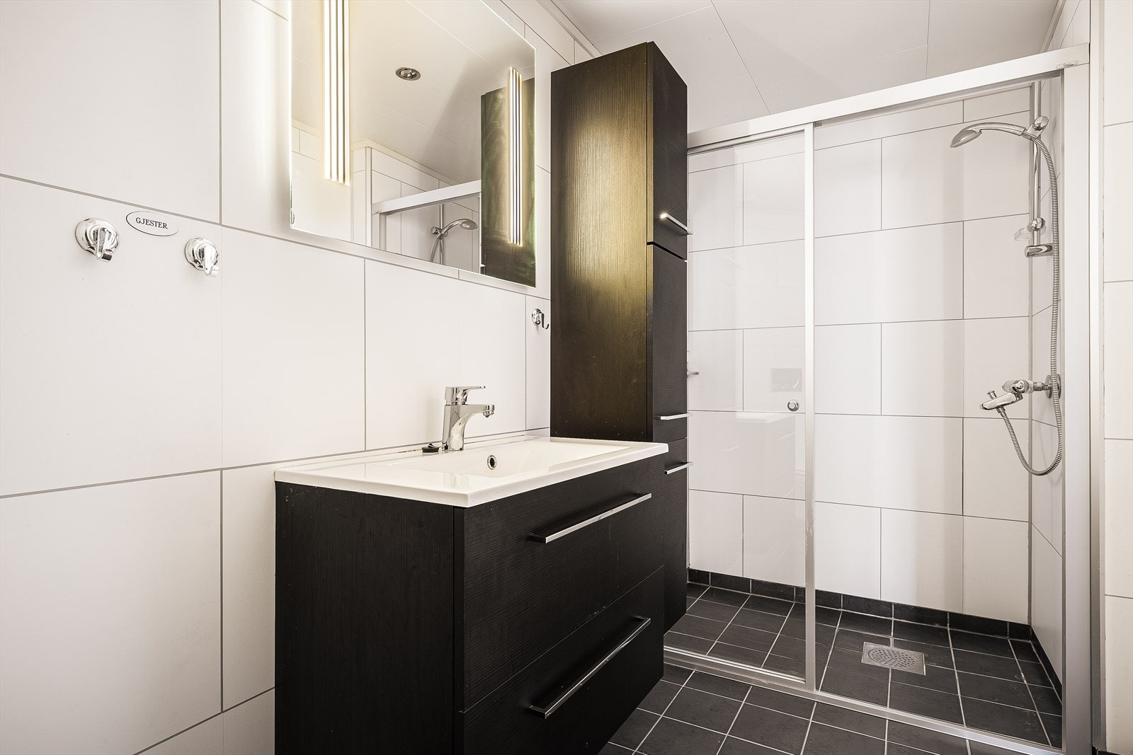 Badet i første etasje har elektriske varmekabler i gulvet og en romslig dusjnisje med skyvedører i glass. Galleribilde