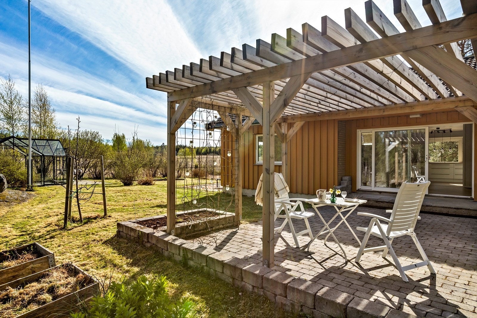 Uteområdene er pent opparbeidet med bl.a. hellebelagte sitteområder, pergola, drivhus og lekeområder. Galleribilde