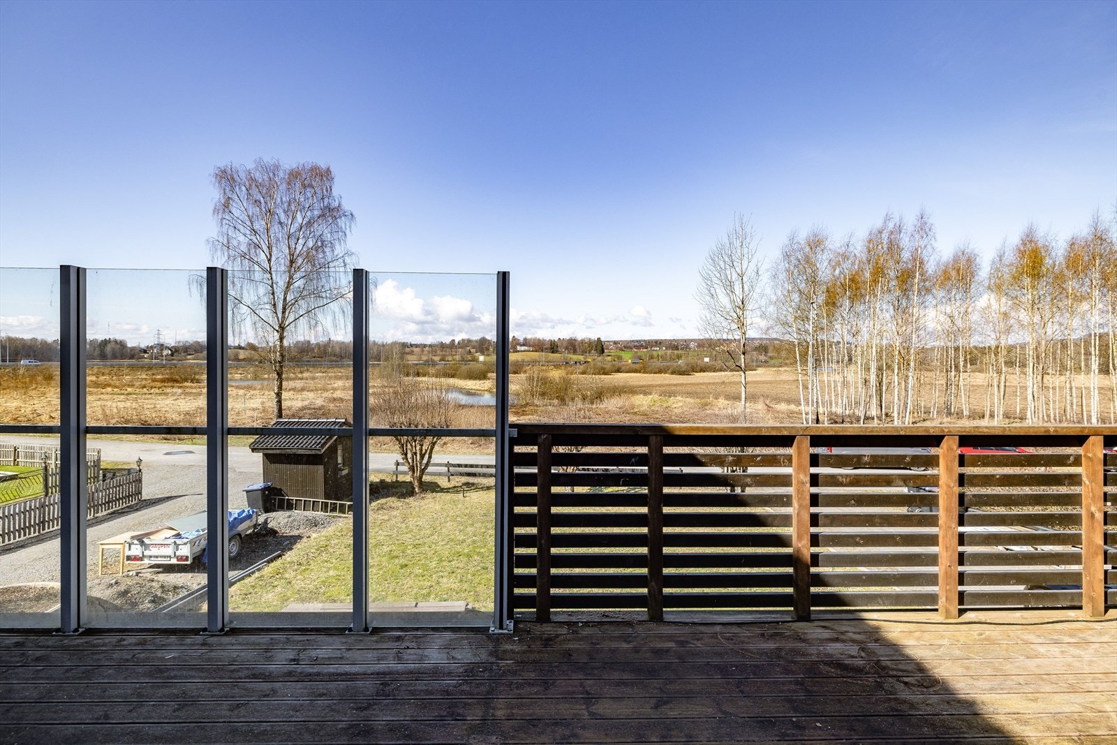 Vestvendt terrasse på 25m². Terrassen som var ny i 2021 har terrassebord på gulv og rekkverk av treverk, metall og glass. Galleribilde