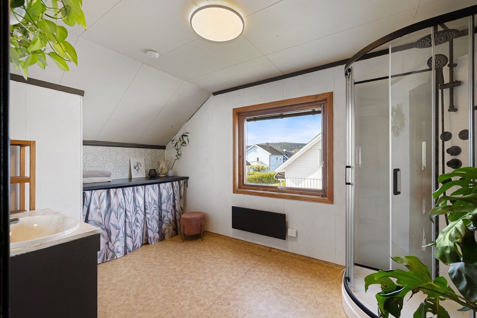 Etasjen har et romslig bad med gulvbelegg på gulv og baderomsplater på vegger. Galleribilde
