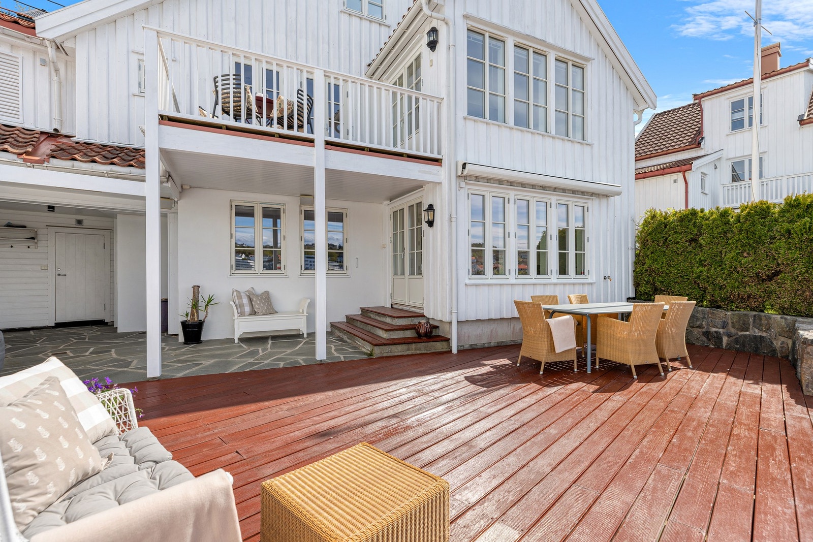 Stor og delvis overbygget uteplass med gode soner for både spisegruppe og loungeområde - perfekt for å nyte lange sommerdager i lune og maritime omgivelser. Galleribilde