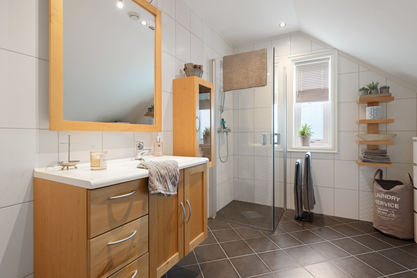 Badet er på hele 6,65 kvm, lagt med keramiske fliser på gulv og vegger og utstyrt med varmekabler i gulv Galleribilde