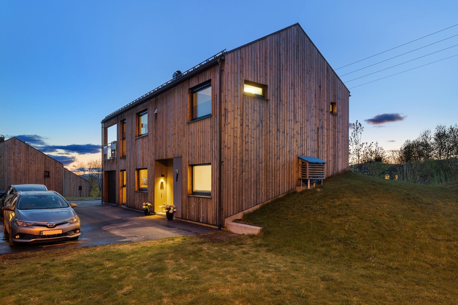 Moderne arkitektur med stående, listefri kledning og vinduer med utvendig aluminiumsbekledning. Galleribilde