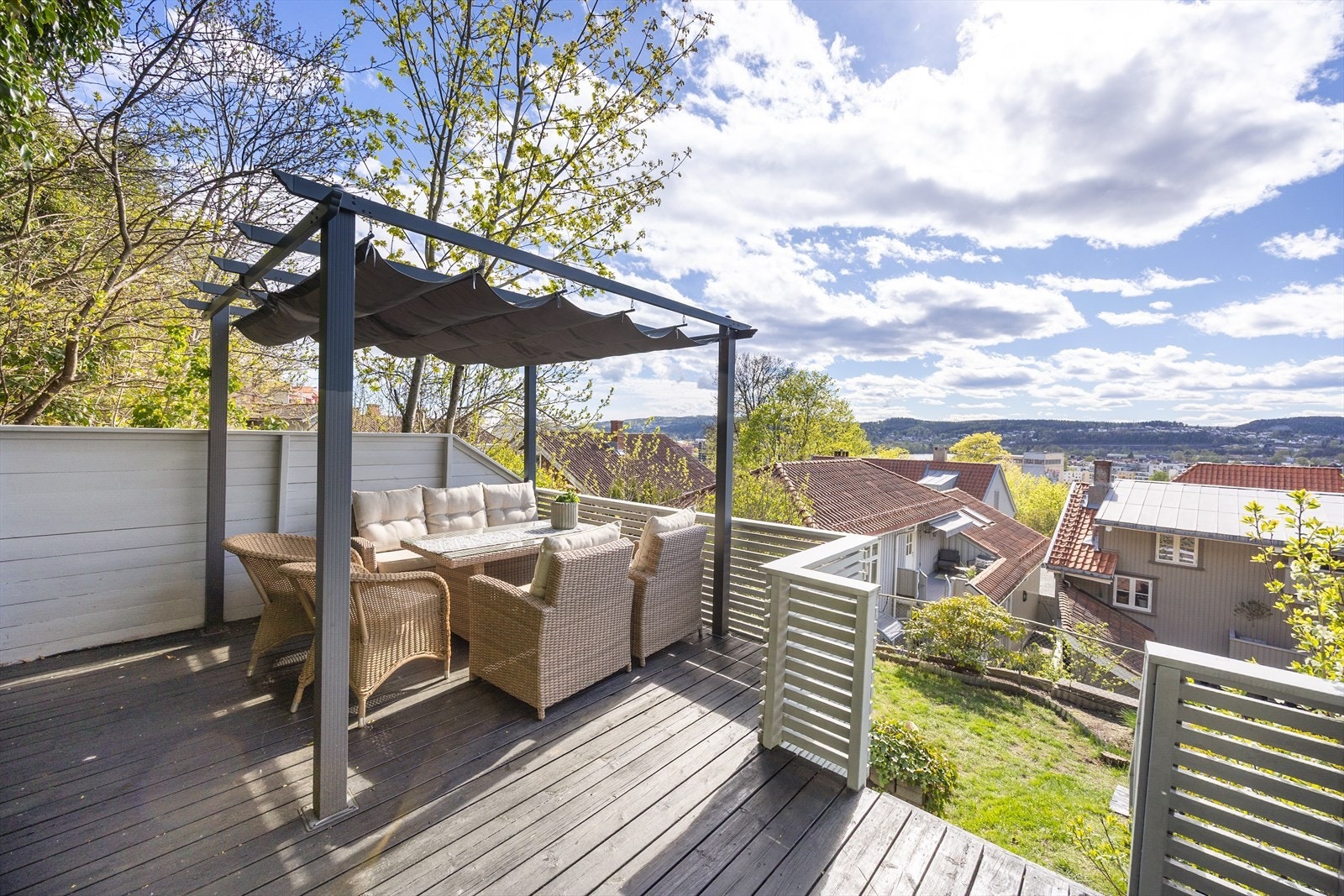 Den romslige terrasseplattingen på toppen av eiendommen har plass til en stor utemøbelgruppe. Galleribilde