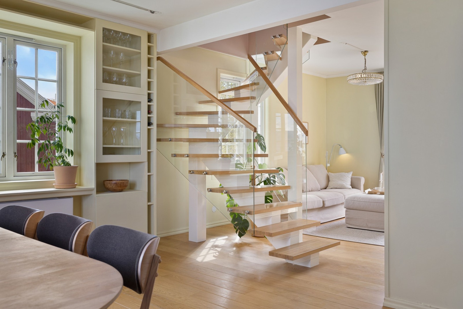 Den eksklusive trappen i heltre med glassrekkverk fremstår som et naturlig blikkfang i boligen, og binder etasjene elegant sammen. Galleribilde