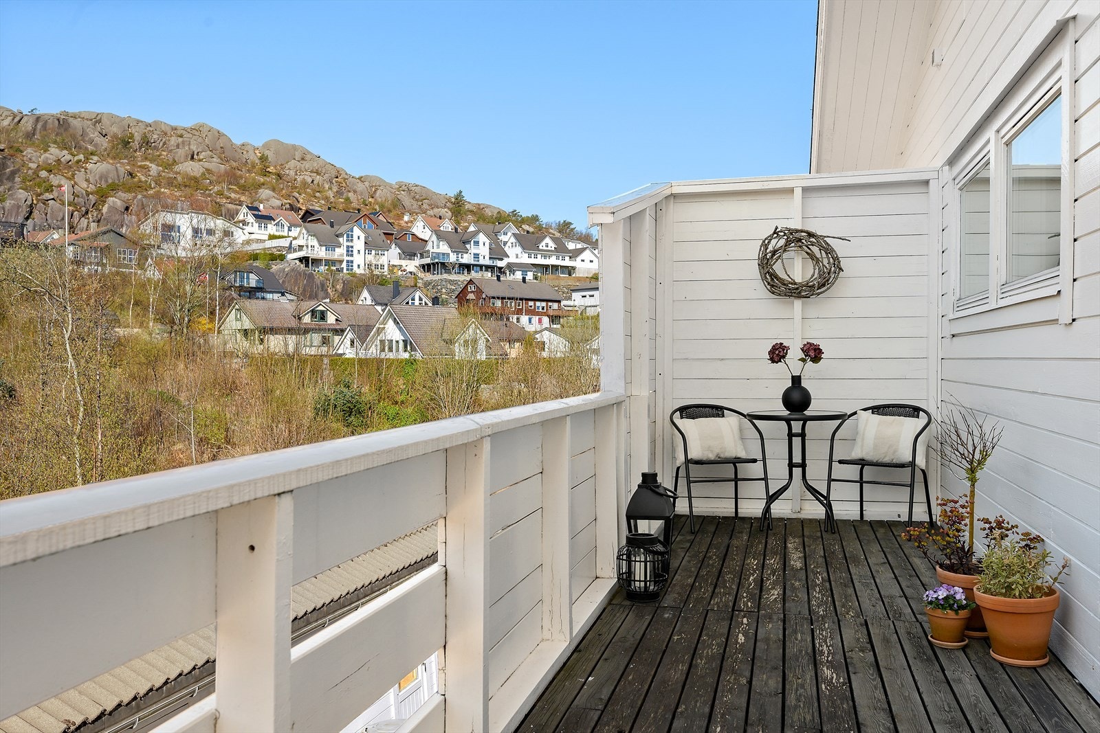 Verandaen er tekket med terrassebord og har rekkverk av tre. Galleribilde