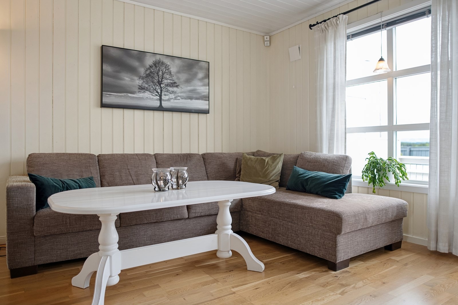 Stuen har parkett på gulvet og malte panelplater på veggene. Galleribilde