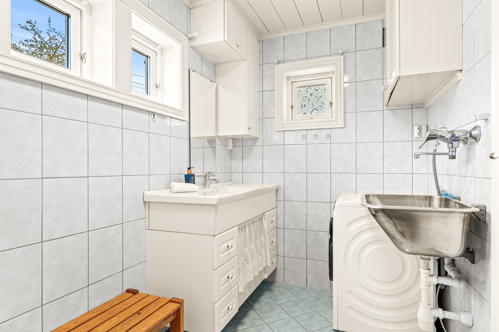 Badet i første etasje har flislagt gulv med varmekabler og praktisk opplegg for vaskemaskin. Galleribilde