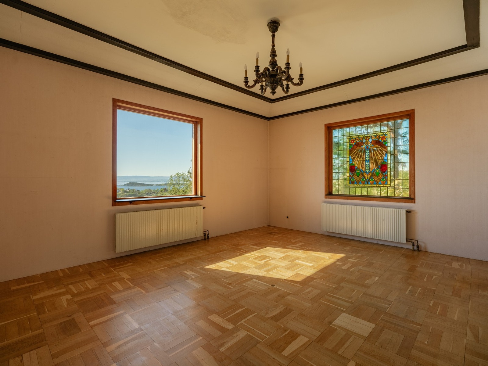 En sjarmerende glassmosaikk i det ene vinduet, og utsikten i det andre. Galleribilde
