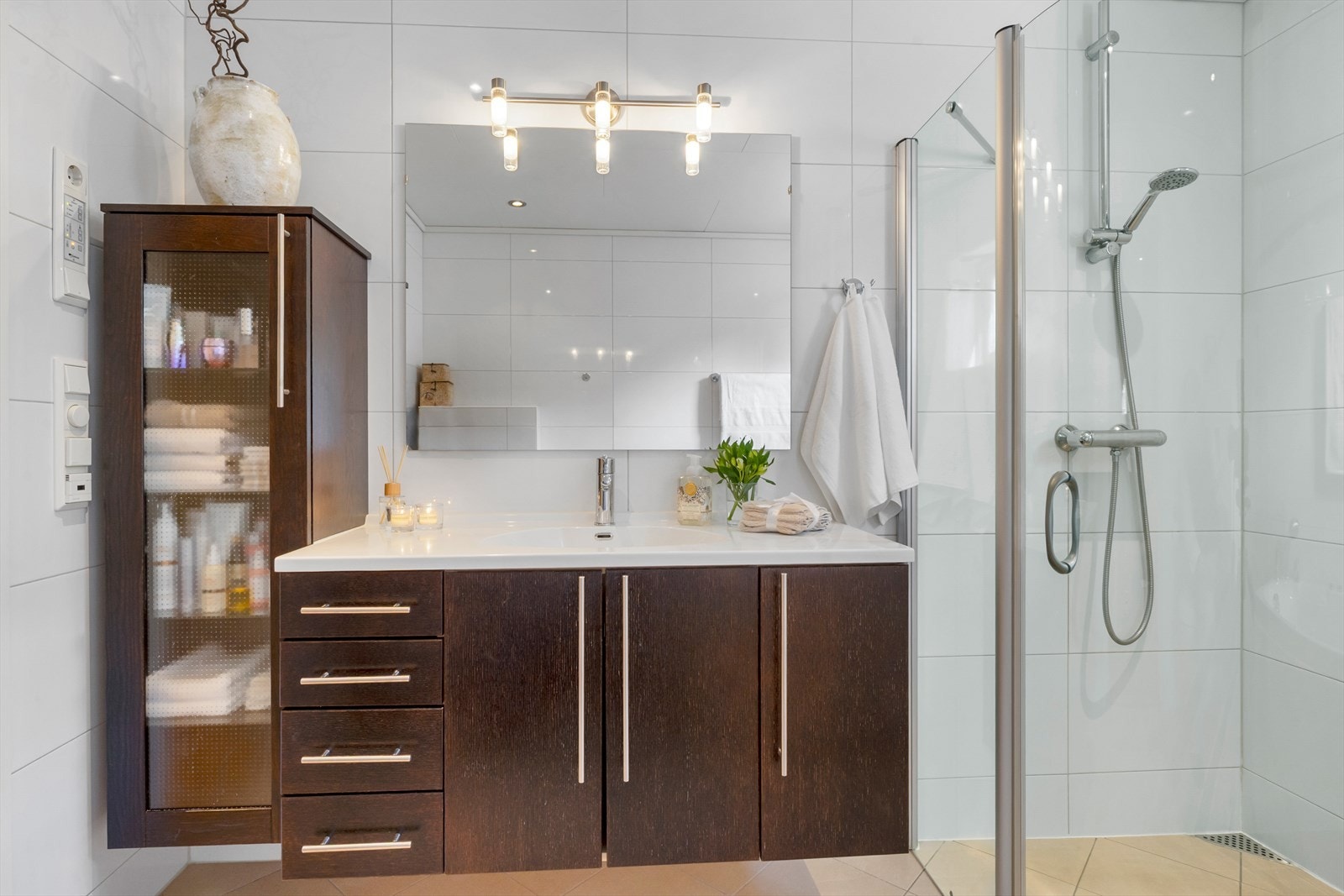 Badet har keramiske fliser på golv og veggar, varmekablar og downlights i taket. Galleribilde