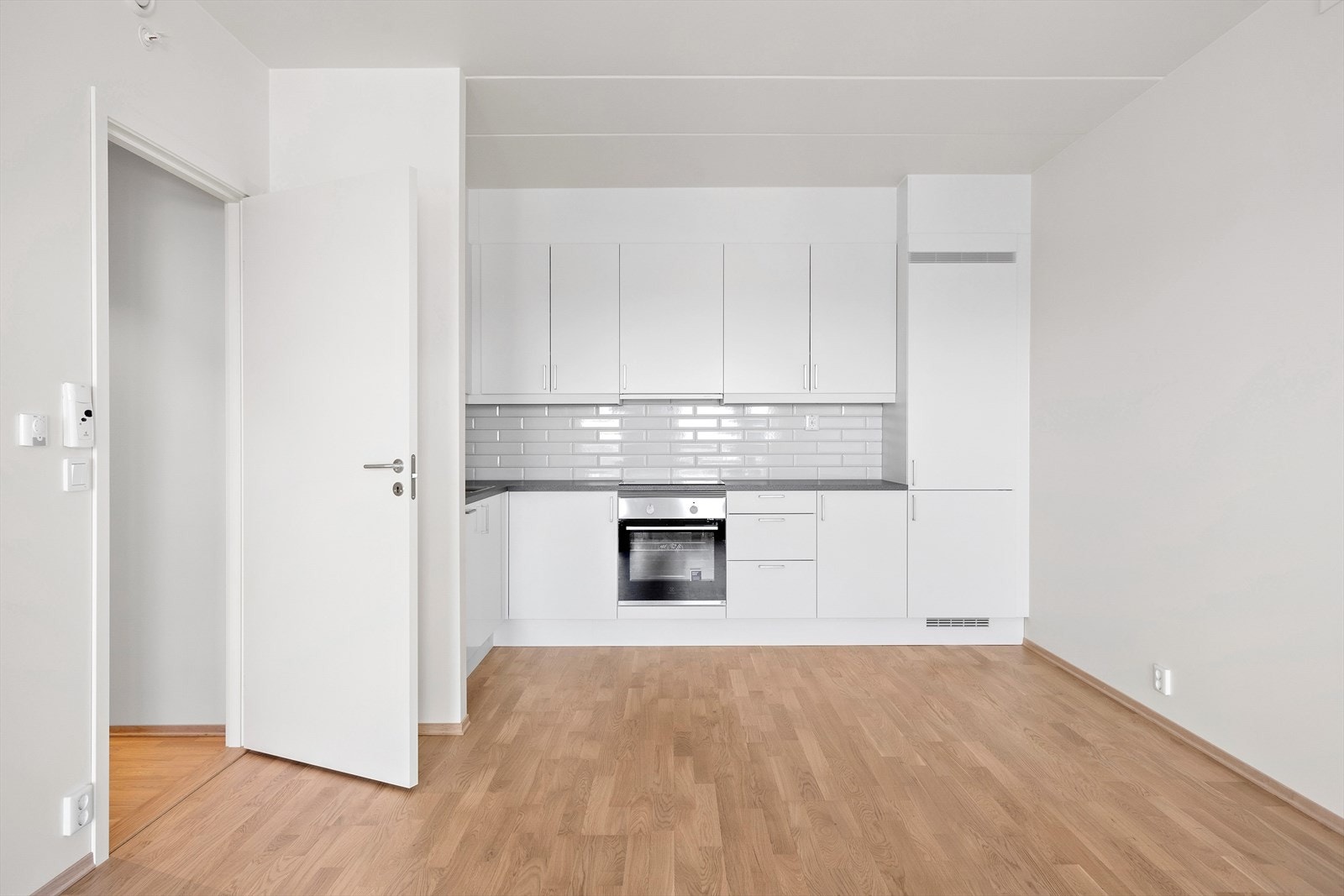 Stilrent og funksjonelt kjøkken fra Sigdal av typen Uno Hvit med hvite fronter og laminat benkeplate. Galleribilde