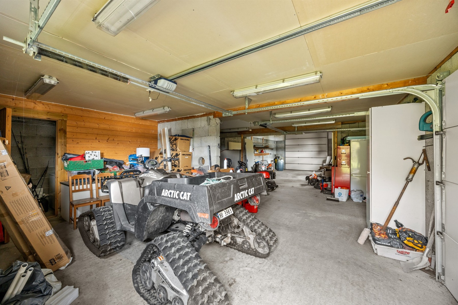 Det er tre garasjeporter som fører inn til parkeringsarealet. Galleribilde