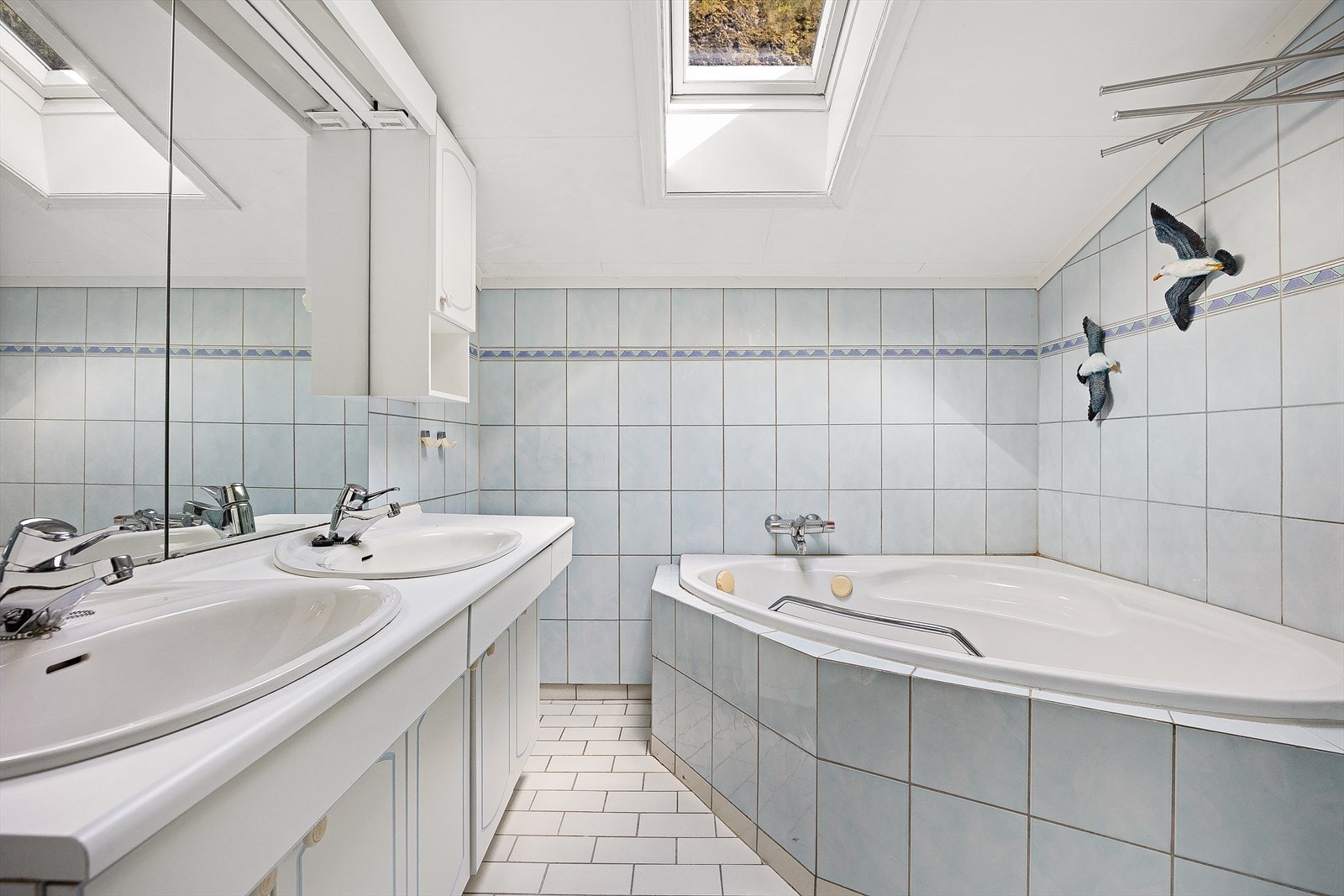 Det er fliser på gulv og vegger, samt varmekabler i gulvet. Galleribilde