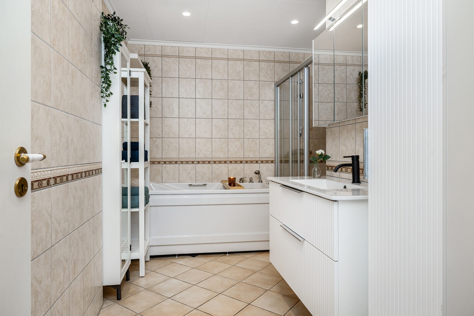 Badet i hovedetasjen har flislagt gulv med gulvvarme og flislagte vegger Galleribilde