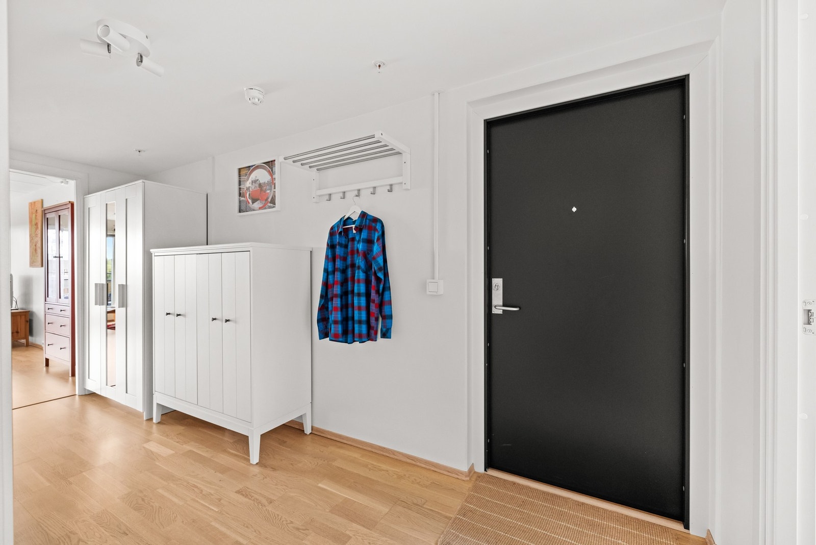 Entréen er innredet med knaggrekke og garderobeskap for rikelig med lagringsplass, og har en lun parkett på gulvene. Galleribilde