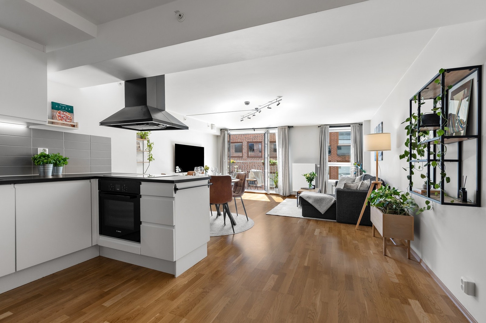 Innbydende stue med 3-stavs parkettgulv, slette veggflater og nedsenket himling med integrerte downlights Galleribilde