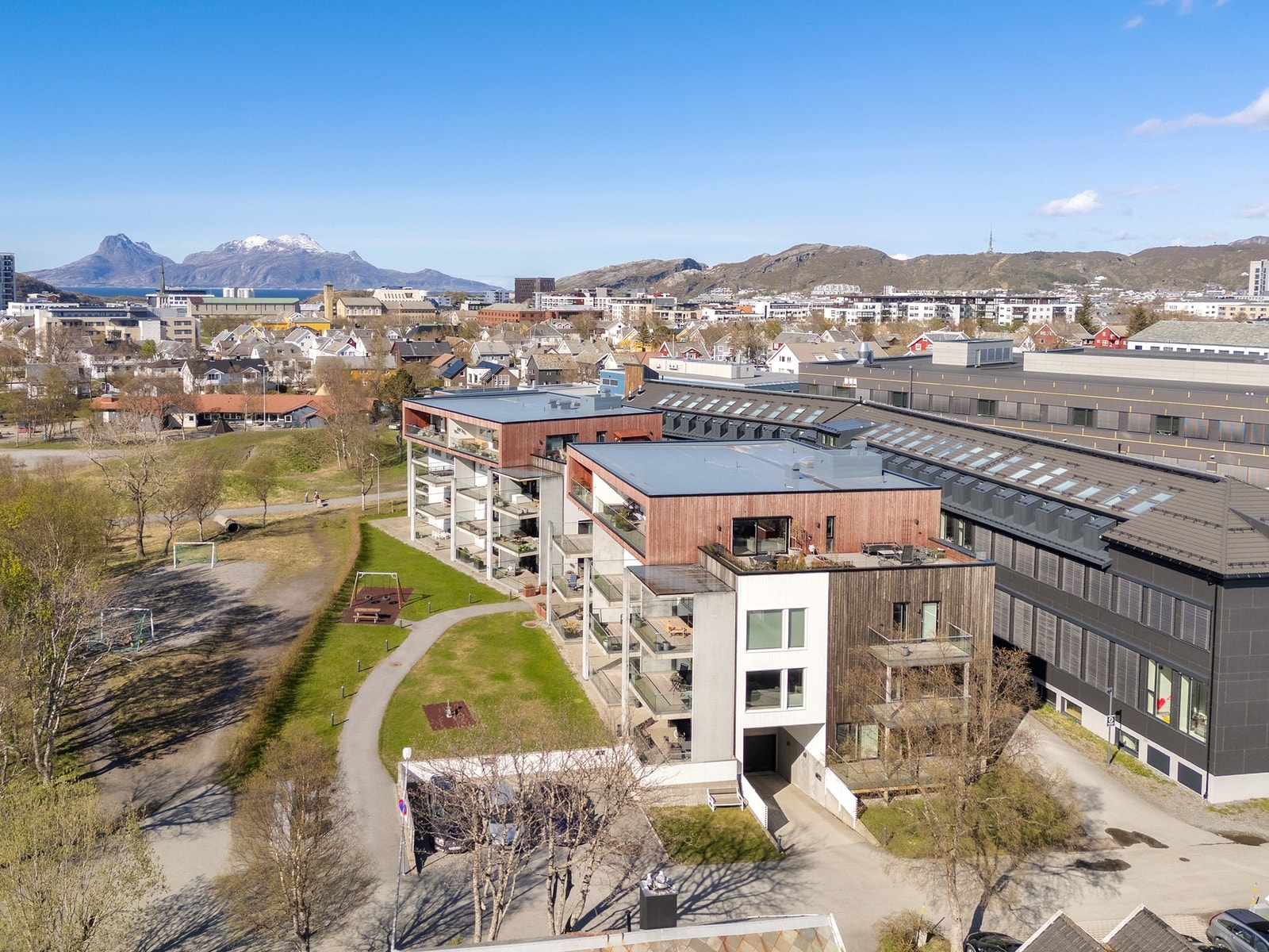 Innkjøring til garasje på sørsiden av blokka, og inngang til bygget på østsiden. Galleribilde